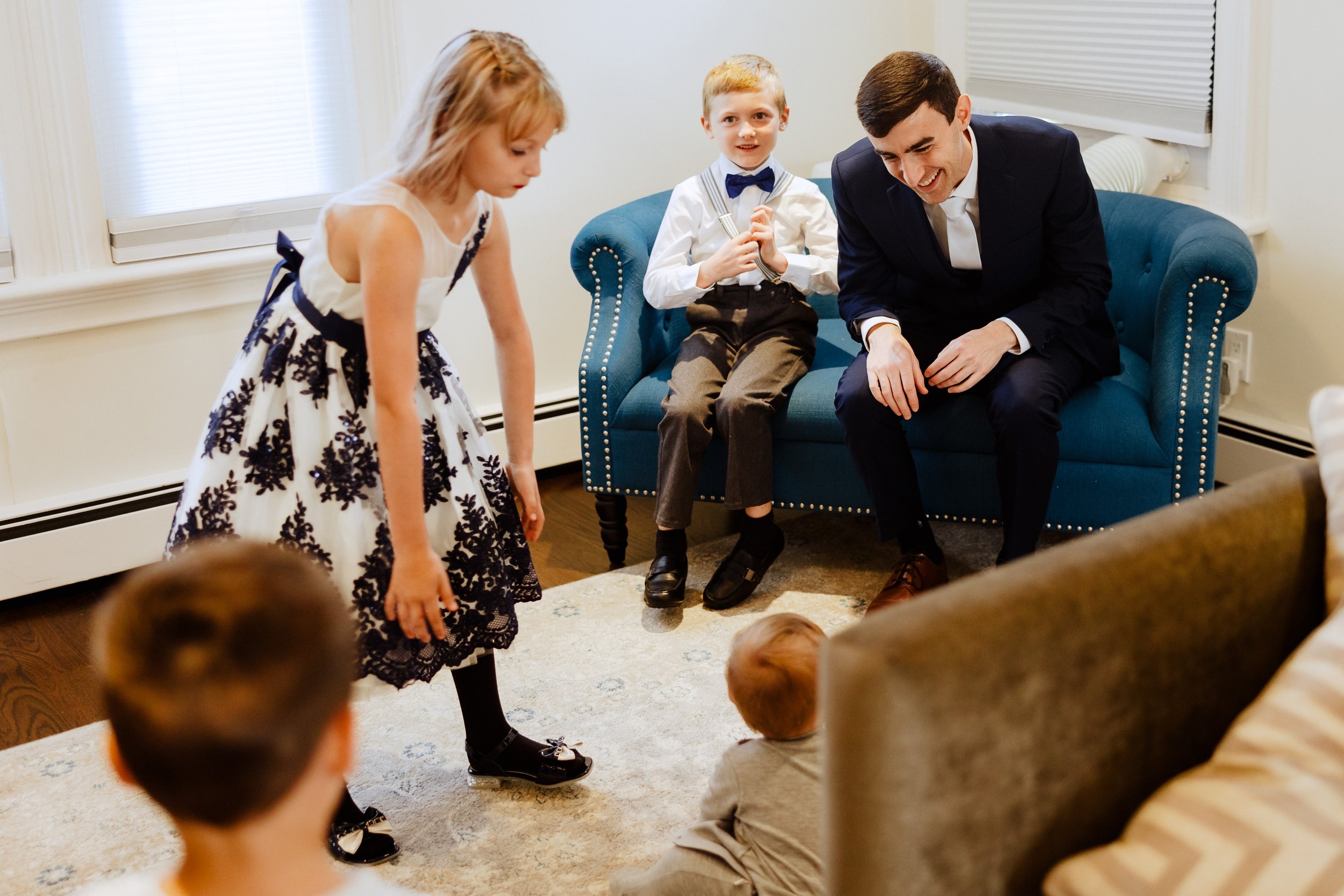  groom smiling and playing with his nieces and nephews 