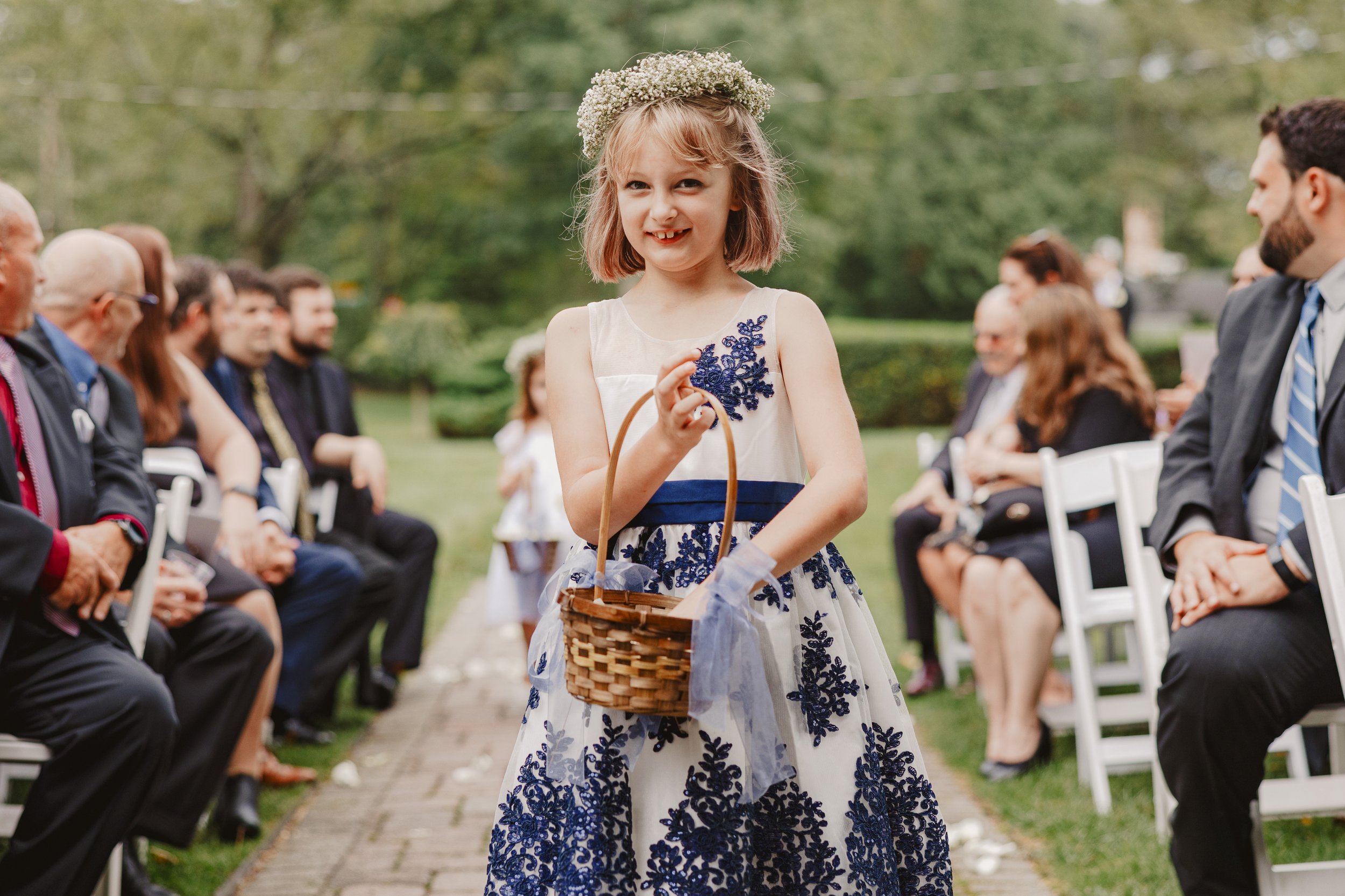  flower girl walking down the aisle at Mountainville Manor 
