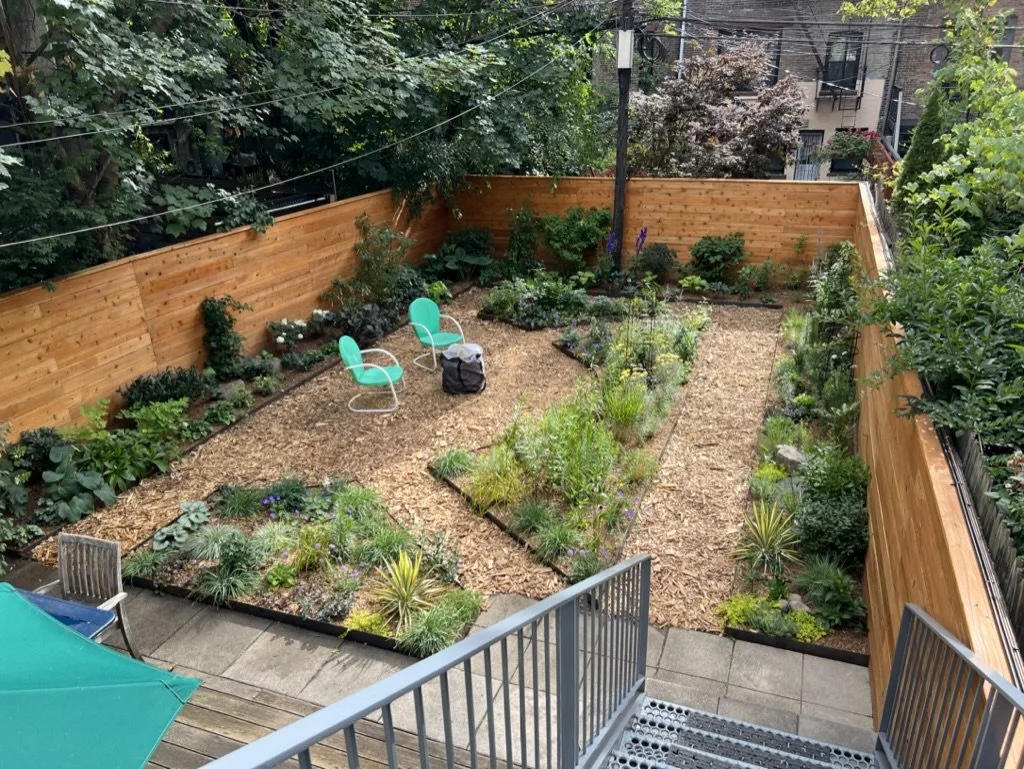 Full garden with custom fencing and mulch pathways