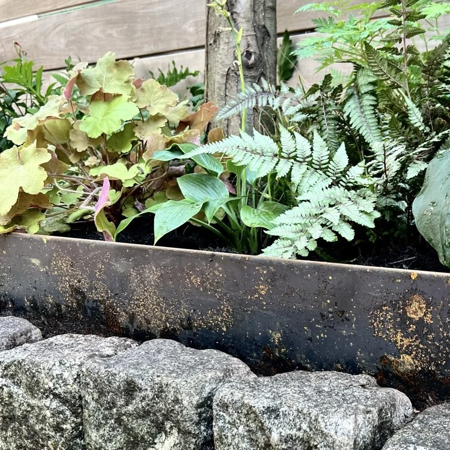 Corten steel edging and cobblestones