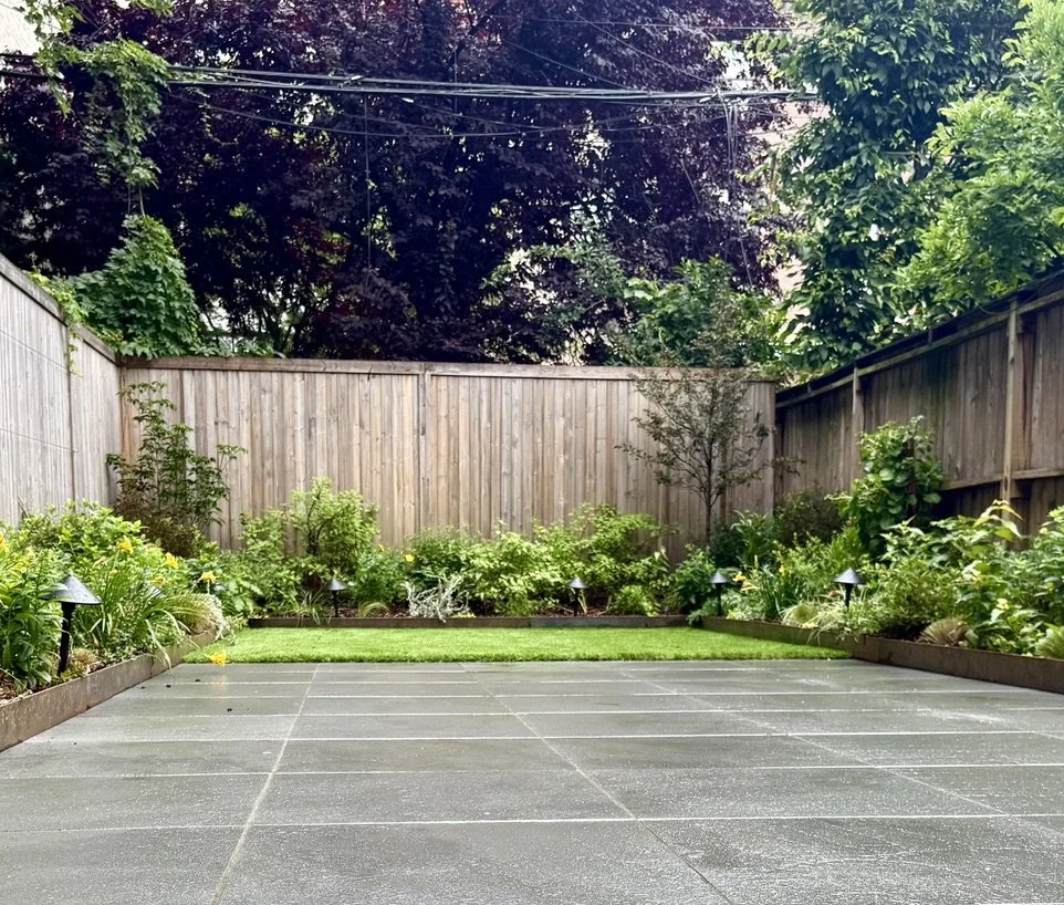 Bluestone patio, turf, and garden lights lining the beds