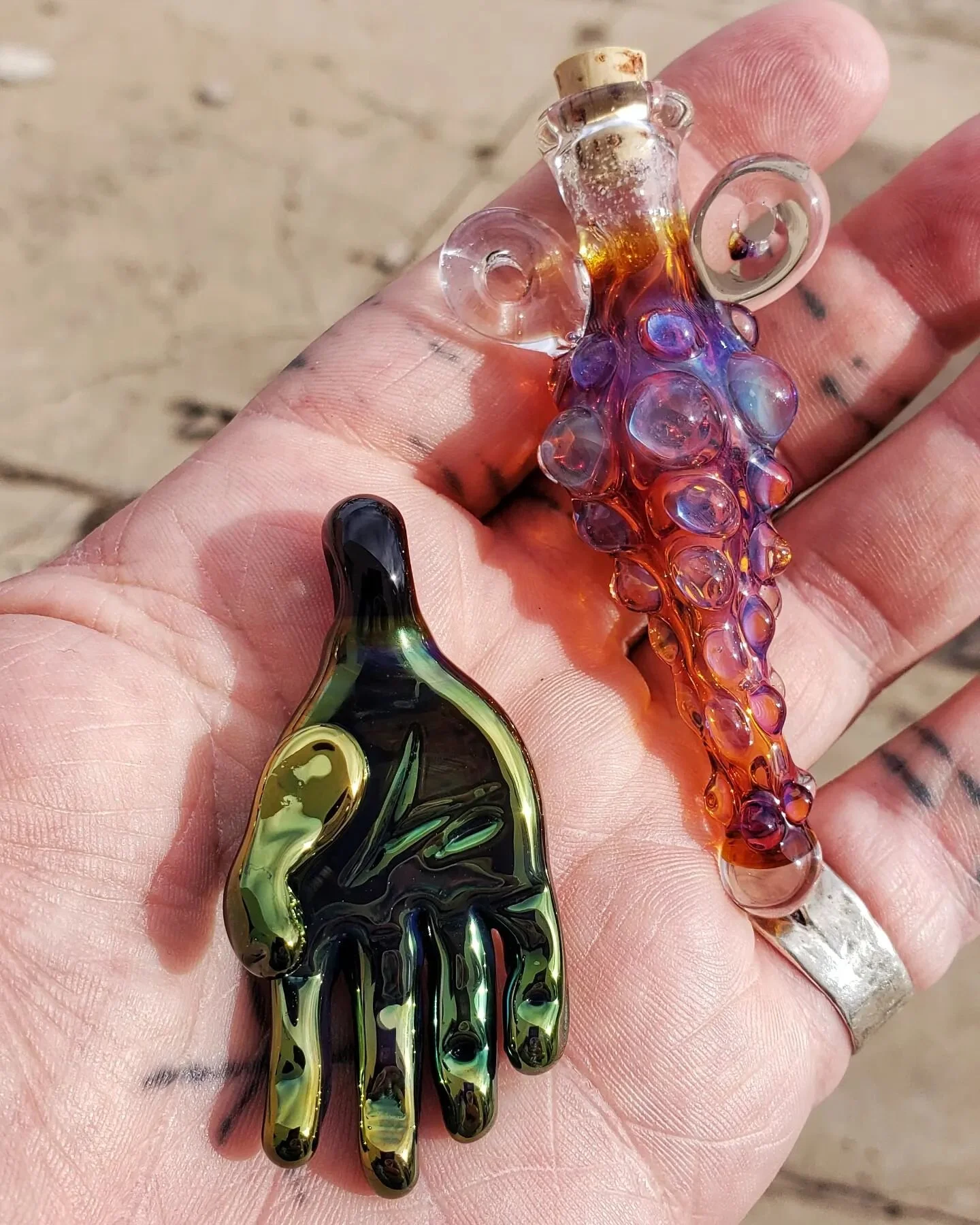 Potion vial, and sculpted glass hand pendant. Will be available at the upcoming Local Con at @theaccelerateddragon_phoenix  the weekend of the 13th and 14th.  Sageglasscuriosities.com #boro #lampwork #witchy #glassjewelry #shopsmall #shoplocal