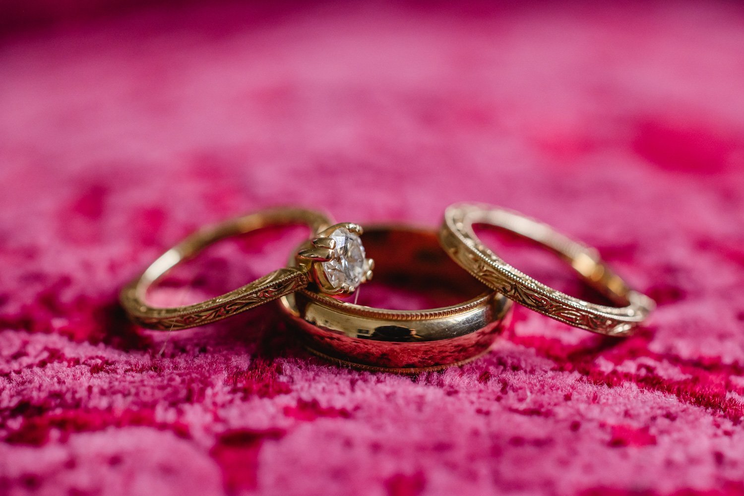 Wedding bands on pink pillow