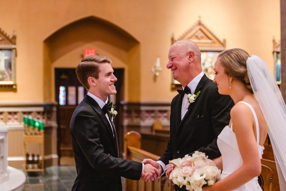 Proud father shakes groom's hand at St Mary's Cathedral in Peoria