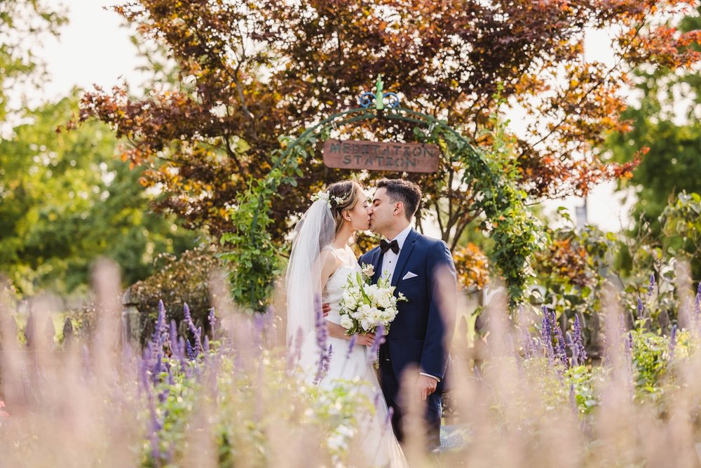 Bride and groom kiss at University of Illinois Arboretum