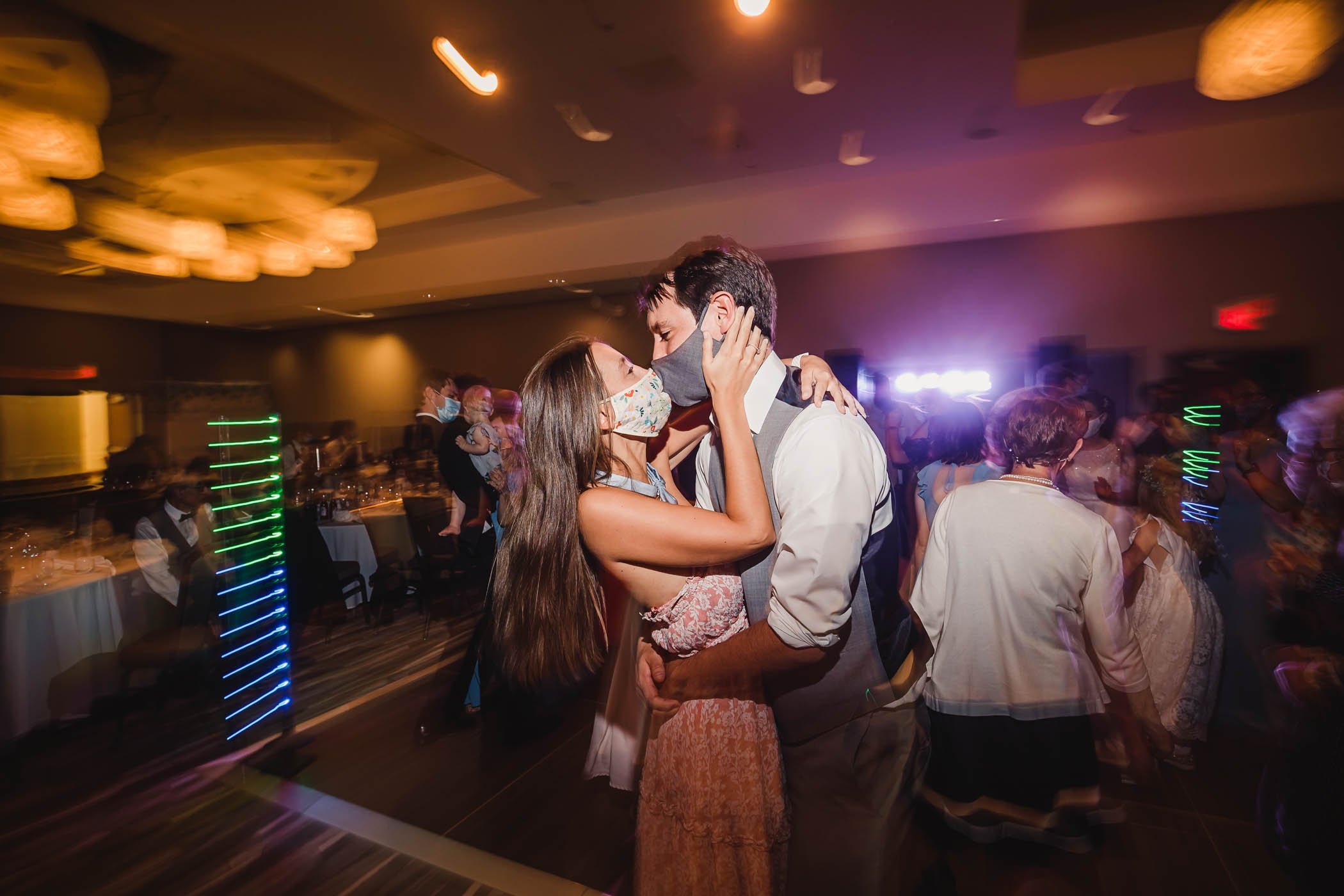 Covid wedding dancefloor masked kiss