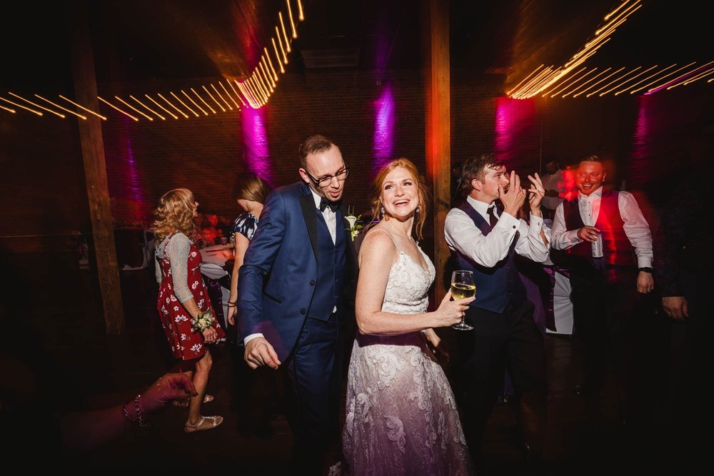 Bride and groom dance at Distillery Room Wedding Reception