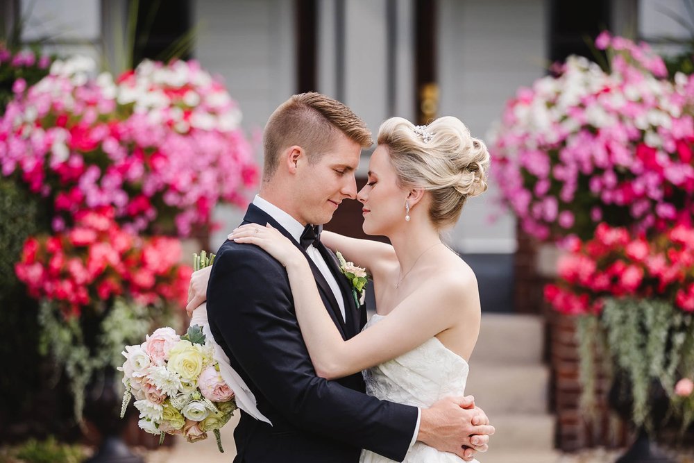 Bride and groom with pink flowers