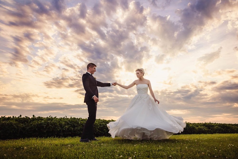 Bride and groom sunset portrait twirl
