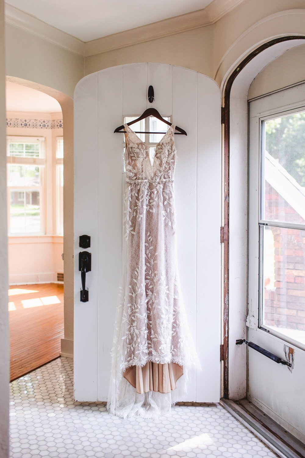 Wedding dress hanging on cottage door