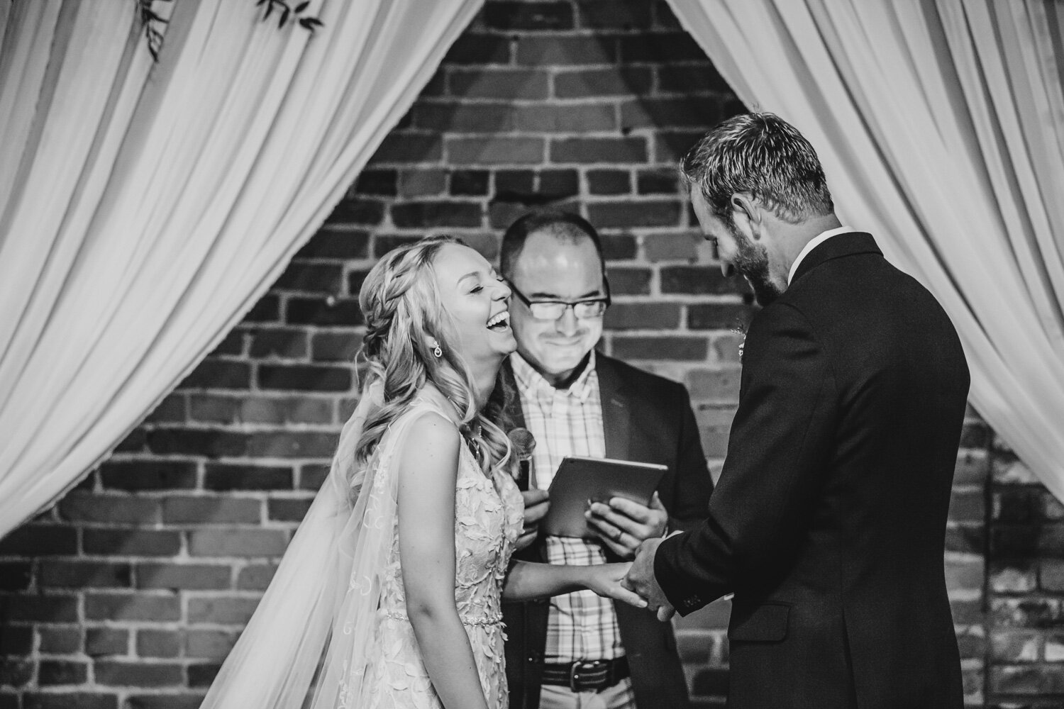 Bride laughs during exchange of rings