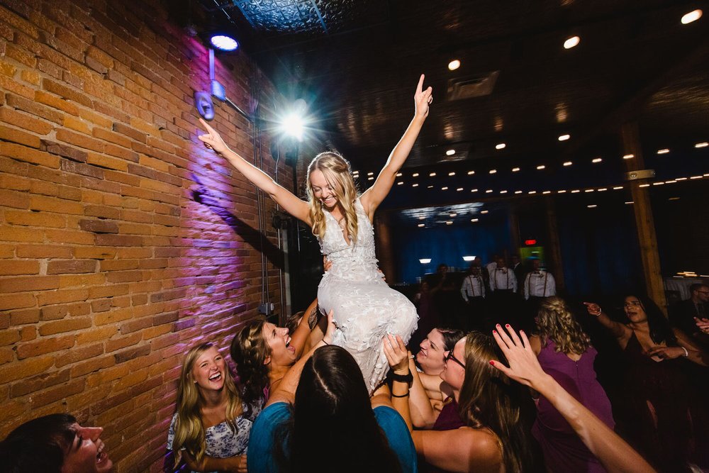 Bride lifted by friends on dancefloor at The Waterhouse Peoria IL