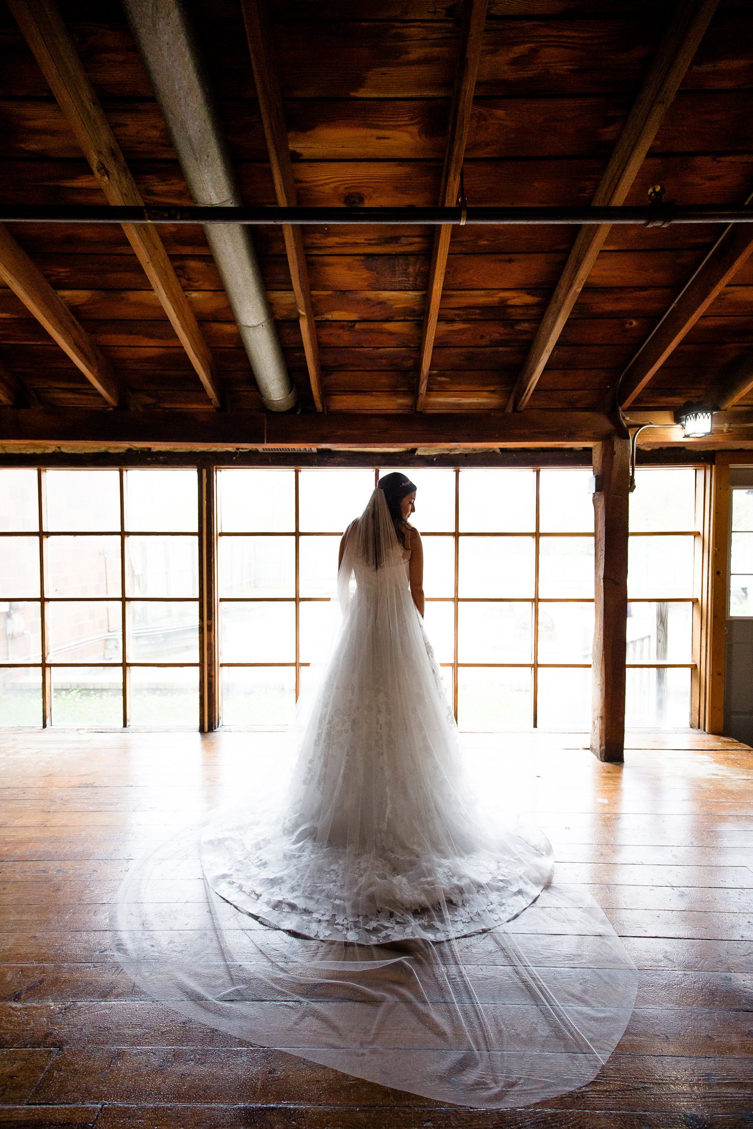 Bride in front of wall of windows