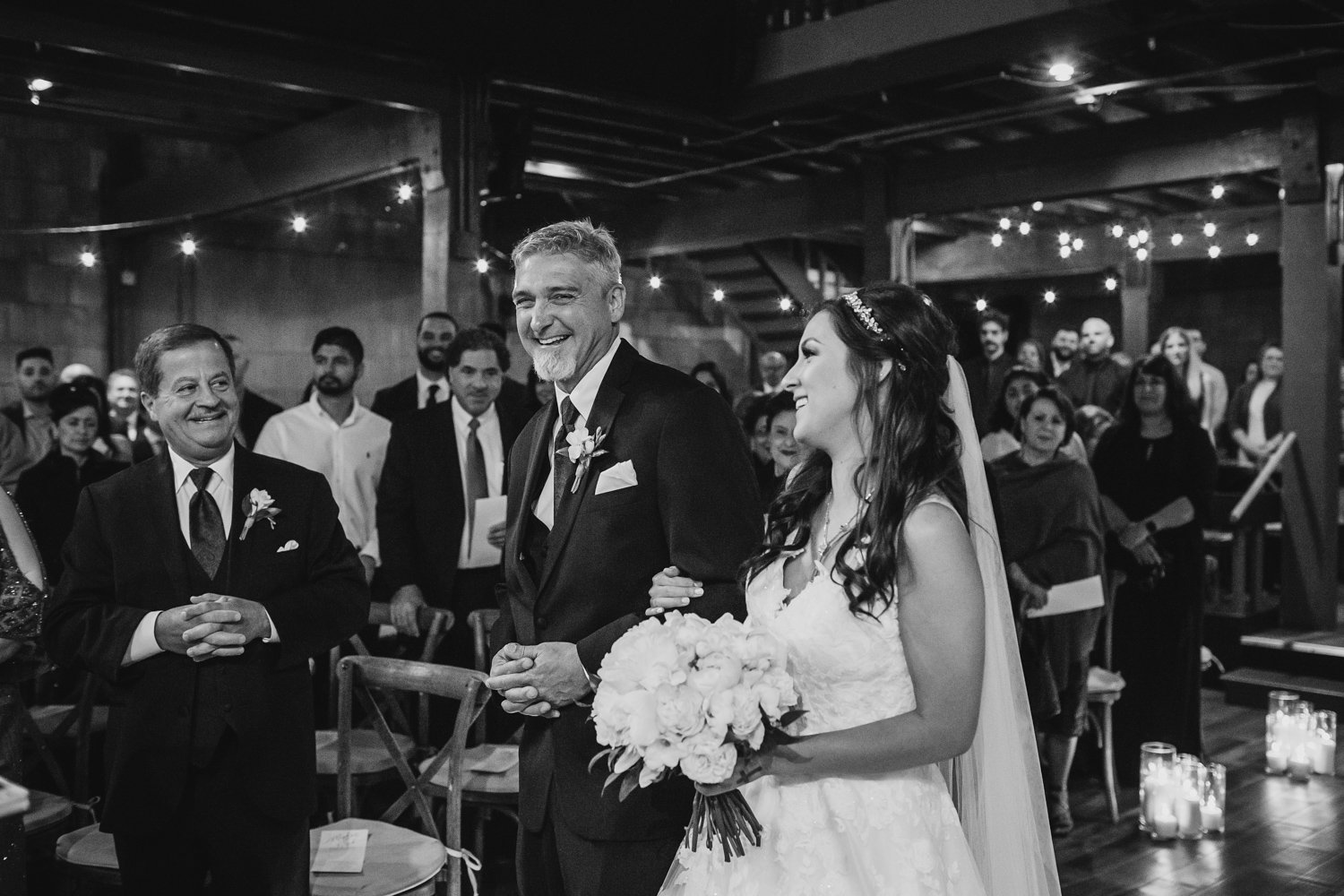 Bride and father laugh at wedding