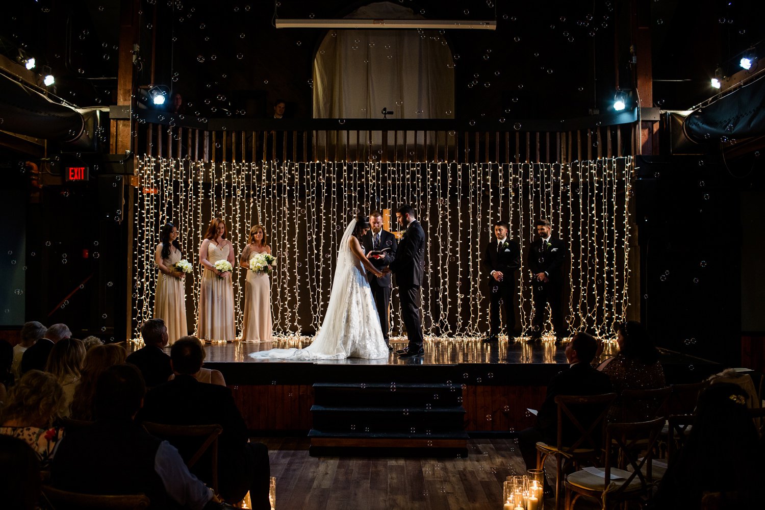 Wedding ceremony with bubbles and string lights