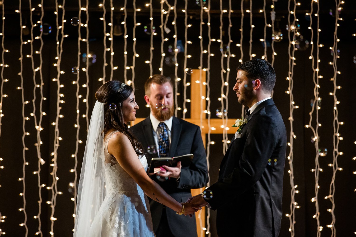 Peoria Wedding ceremony with bubbles and string lights
