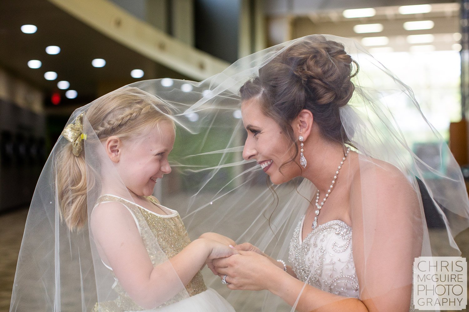 bride and flower girl under veil