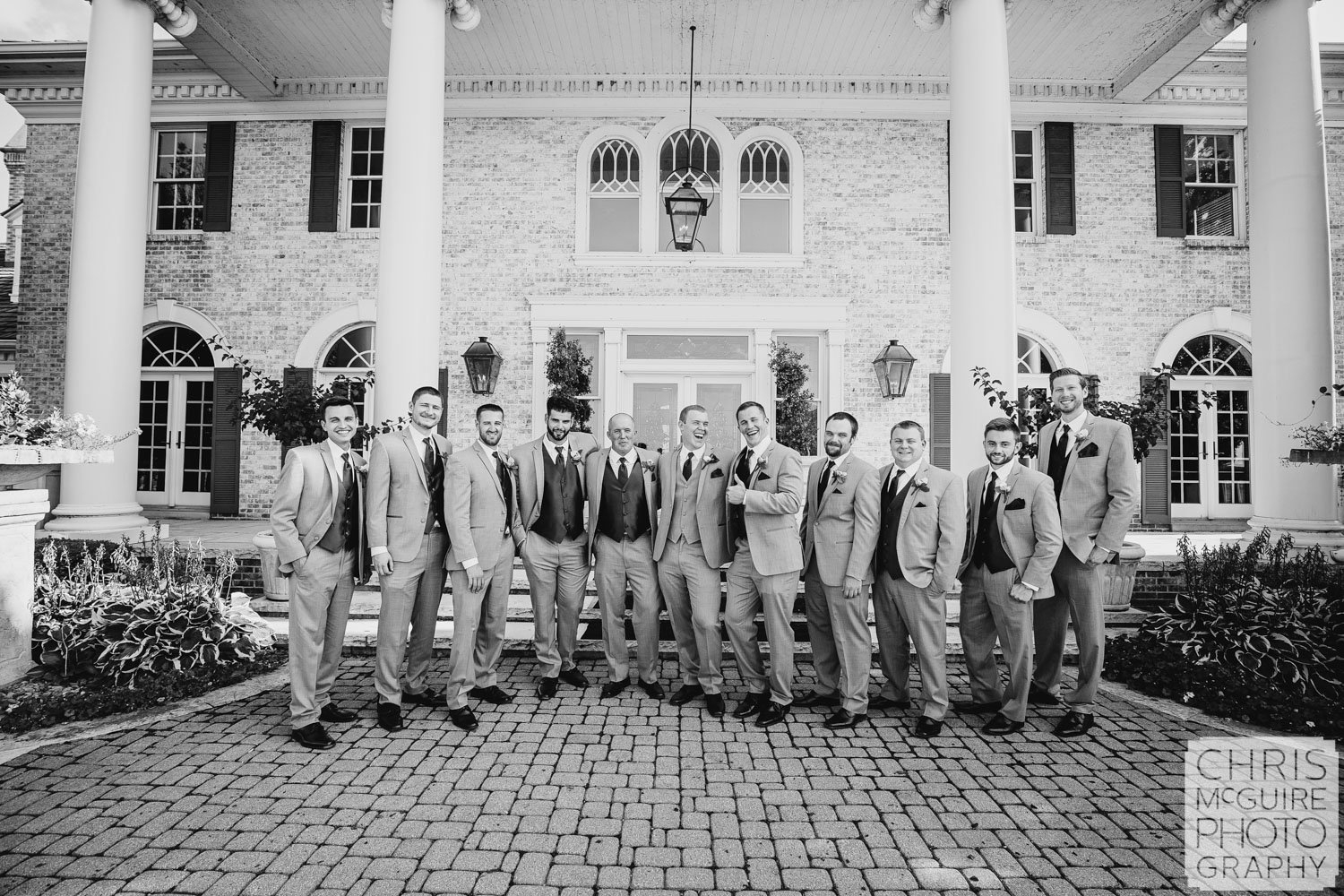 groom laughs with groomsmen midwest wedding