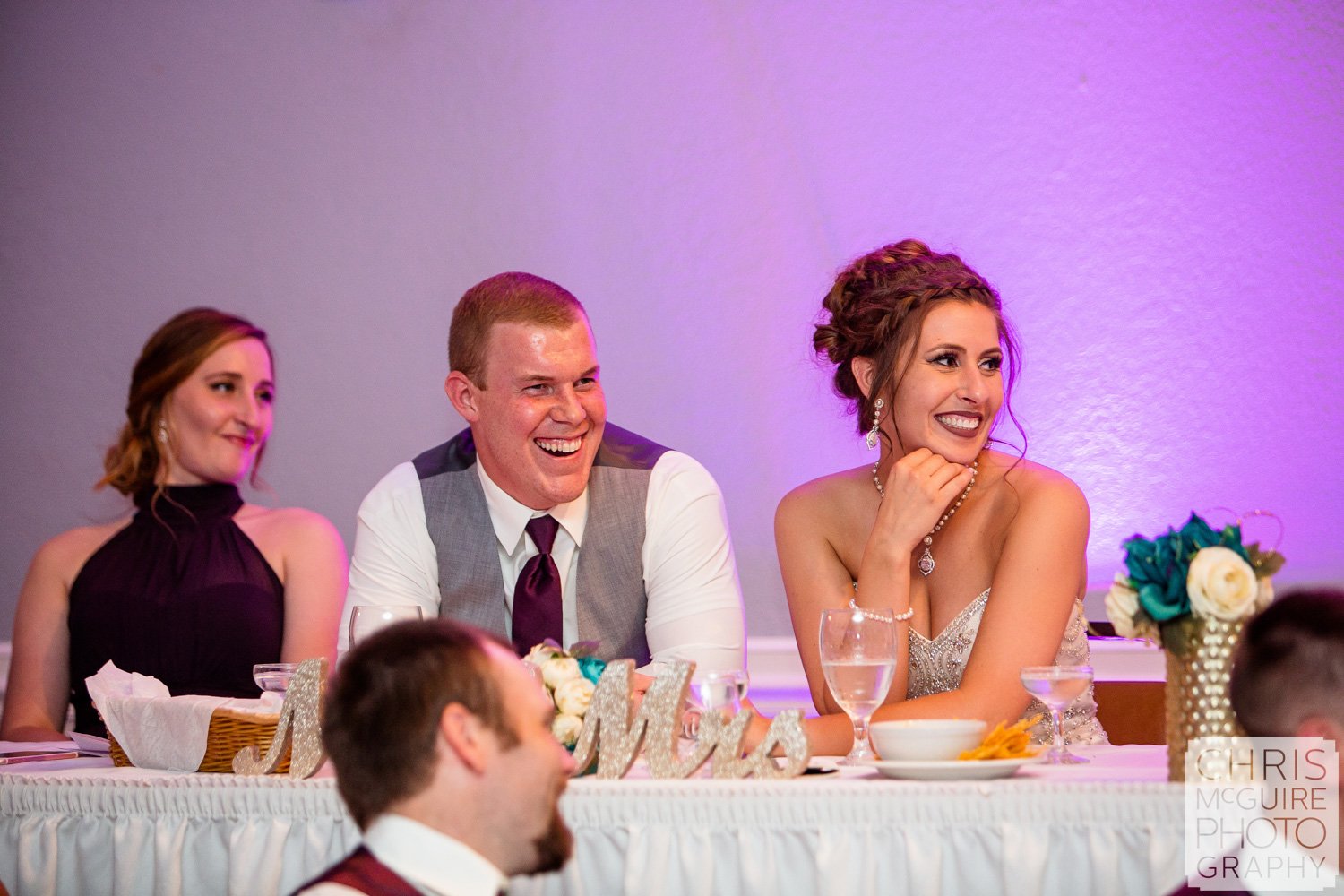 couple laughs during wedding toast