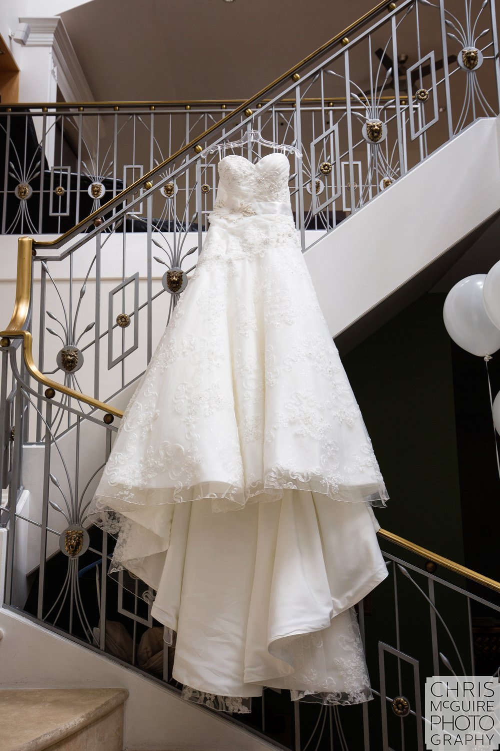 Chicago wedding dress hanging on stairs