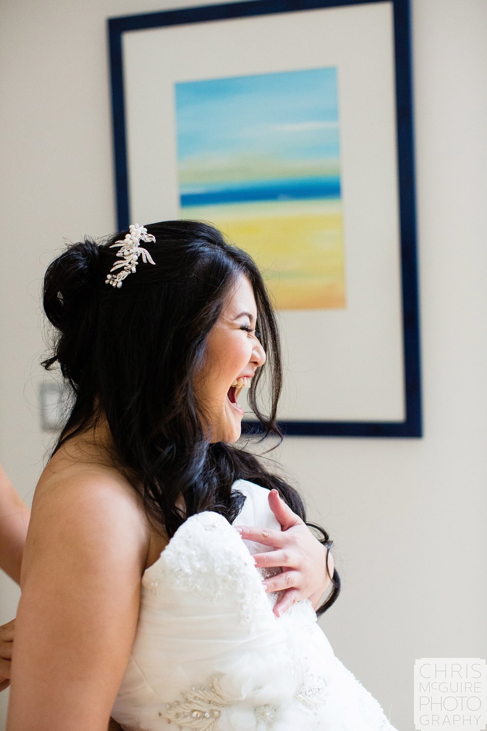 bride laughing while getting ready for wedding