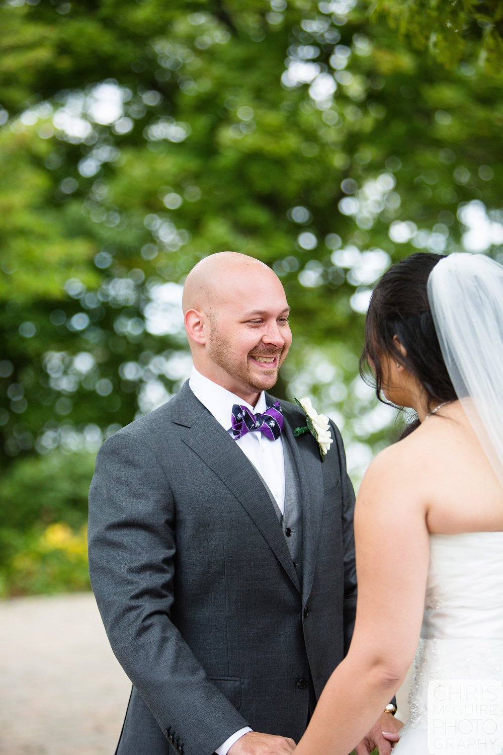 groom smiles at bride during first look