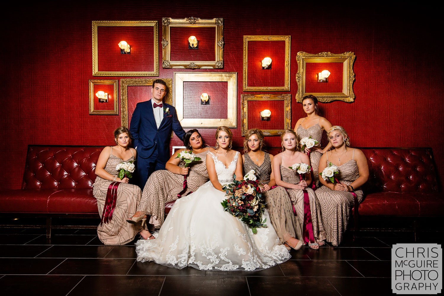 bridal party with red wall