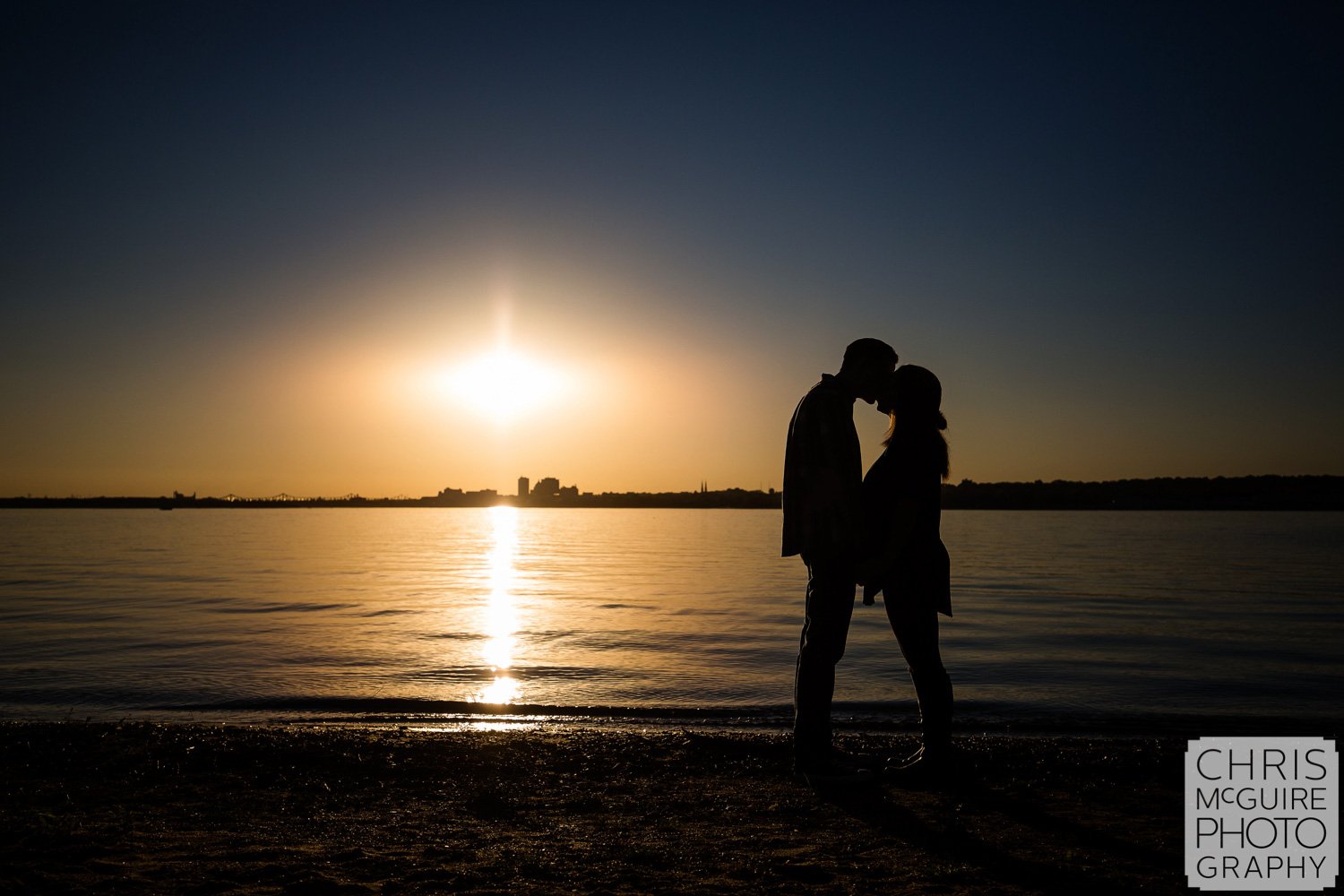 peoria engagement couple kissing by illinois river