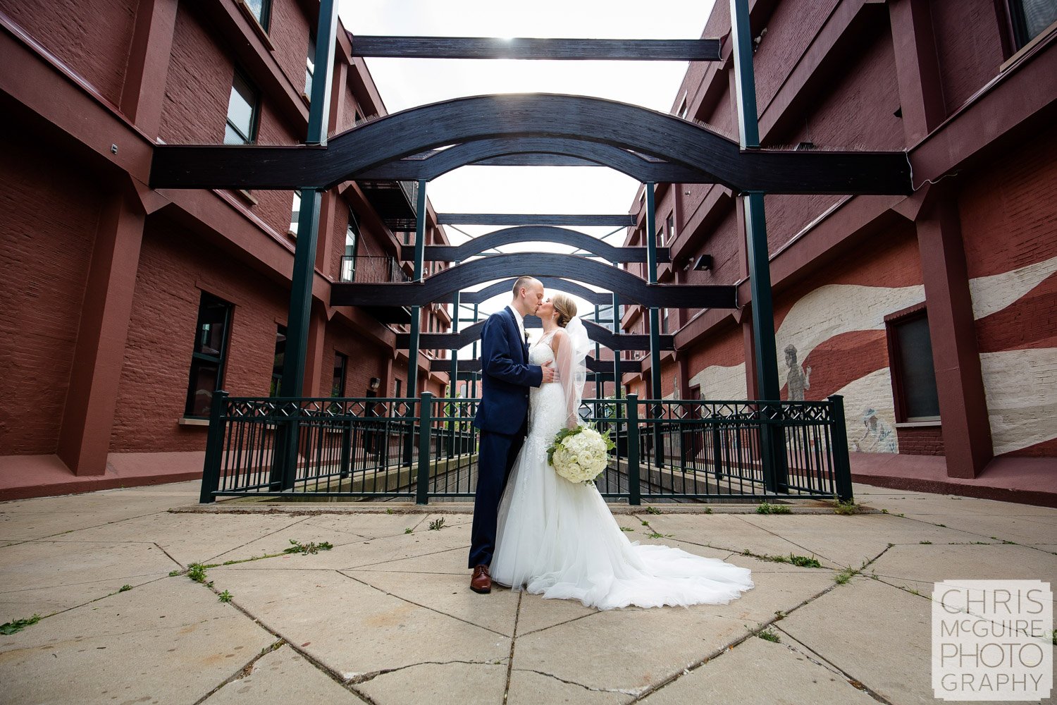 bride groom kiss outside under arches