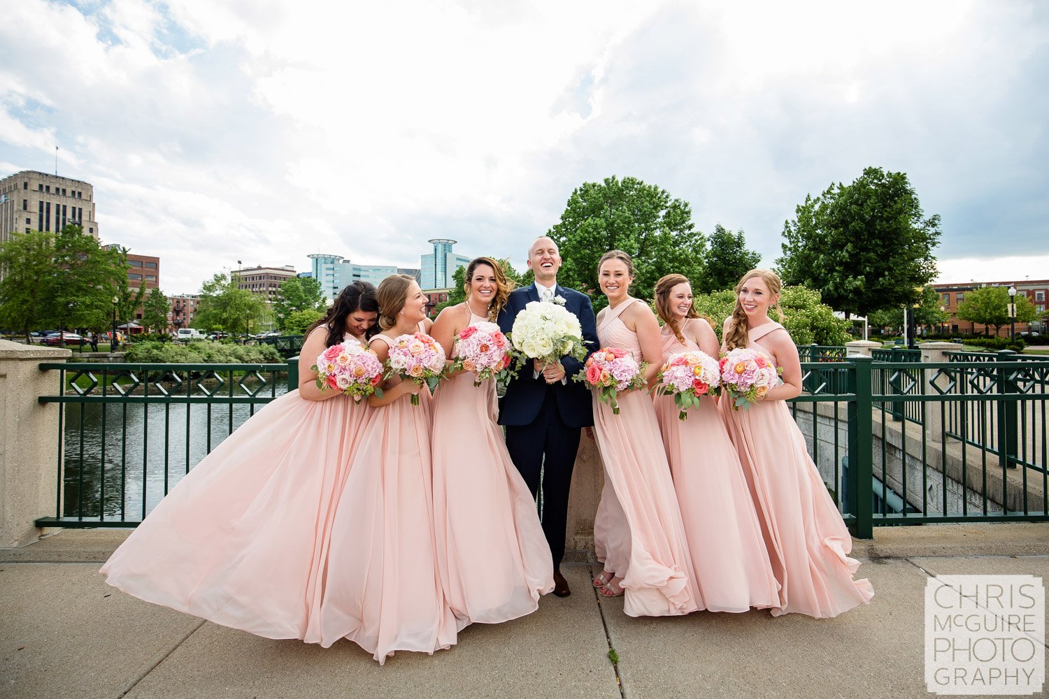 groom and bridesmaids laughing