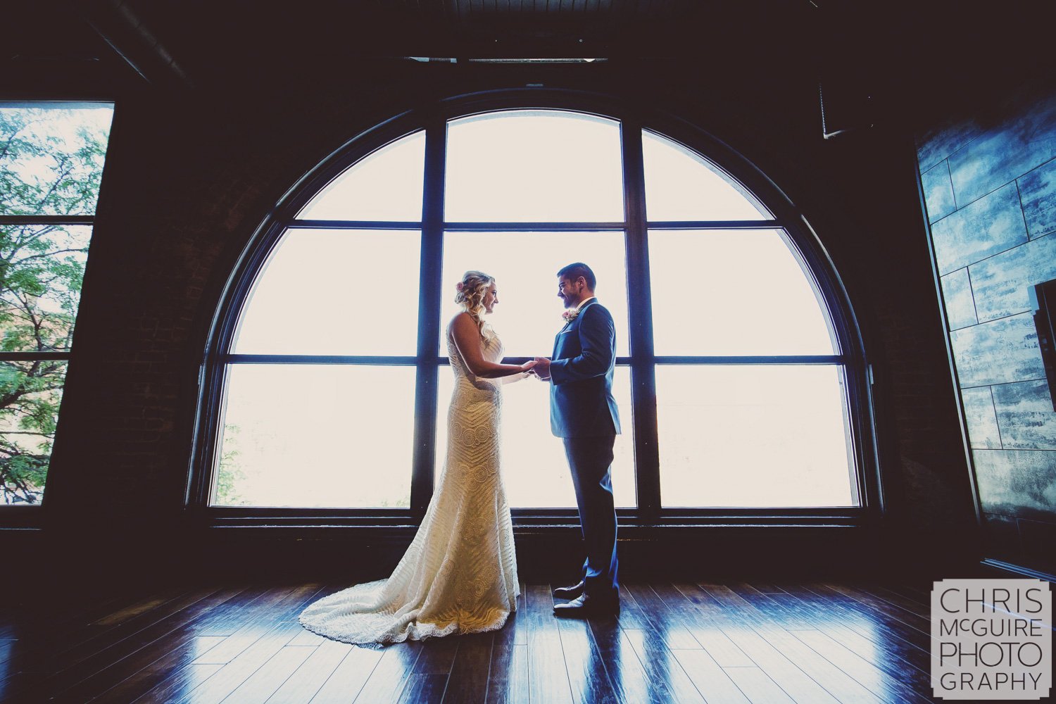 bride and groom portrait in front of window