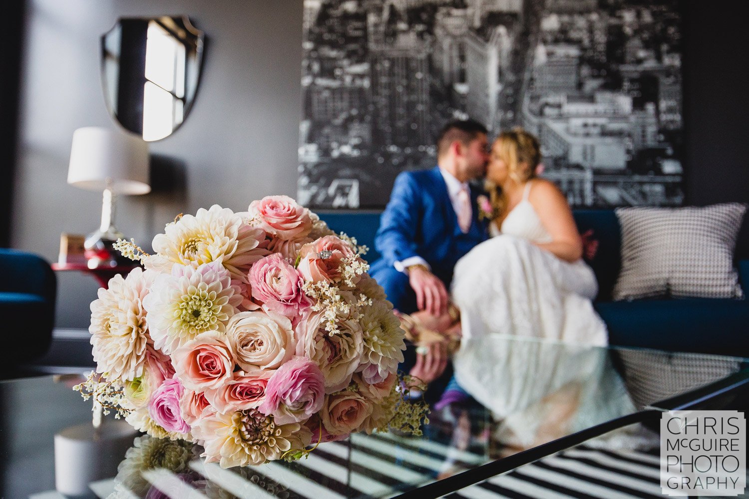 bride groom kissing behind bouquet