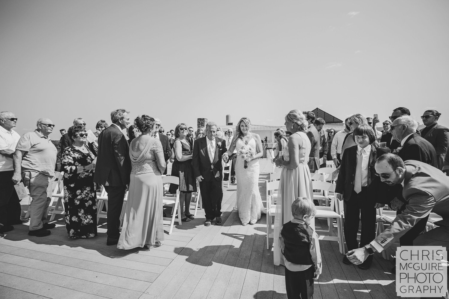 bride and father walking down aisle at rooftop wedding