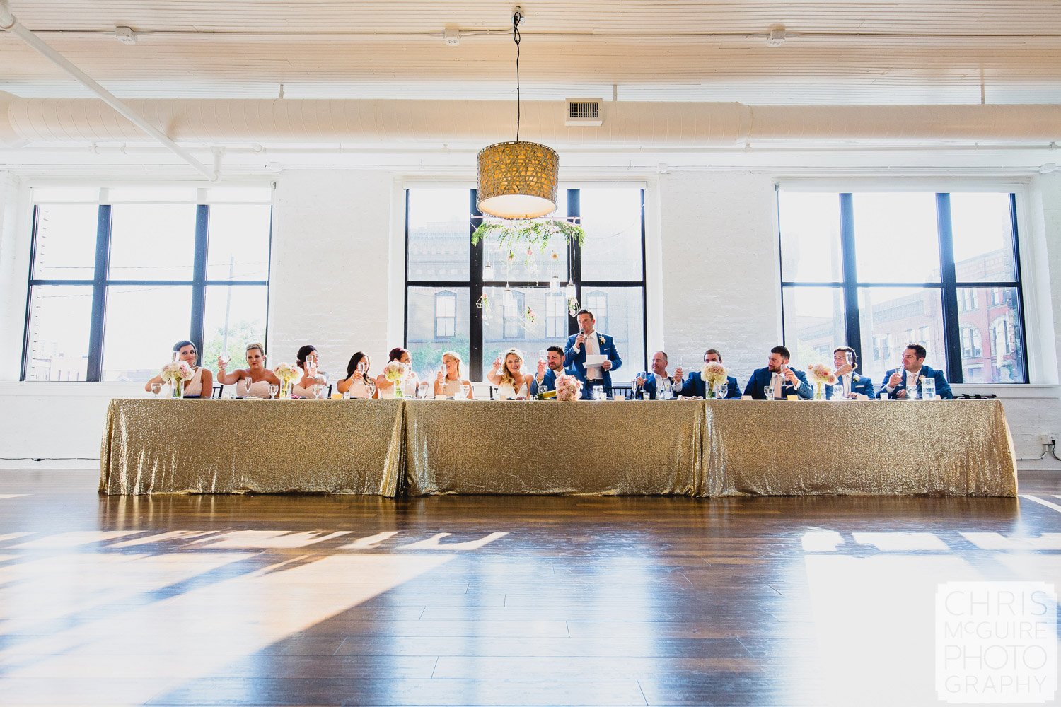 wedding party with gold tablecloth windows