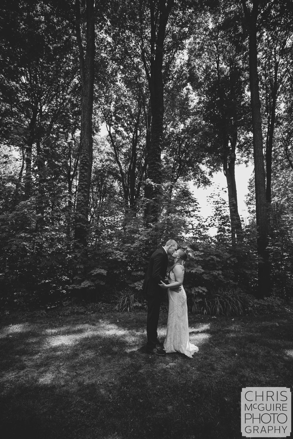 bride groom kissing in woods