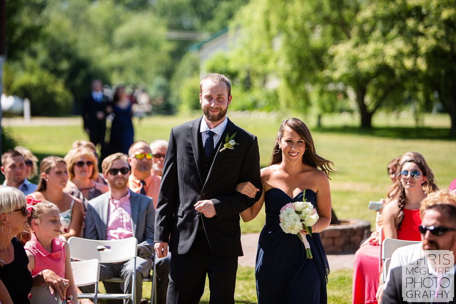 wedding party walking down aisle outdoor candid wedding