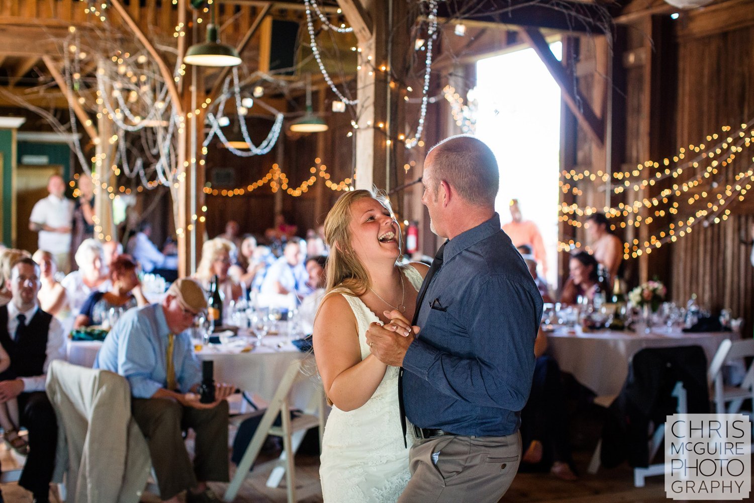 bride dances with father in barn wedding