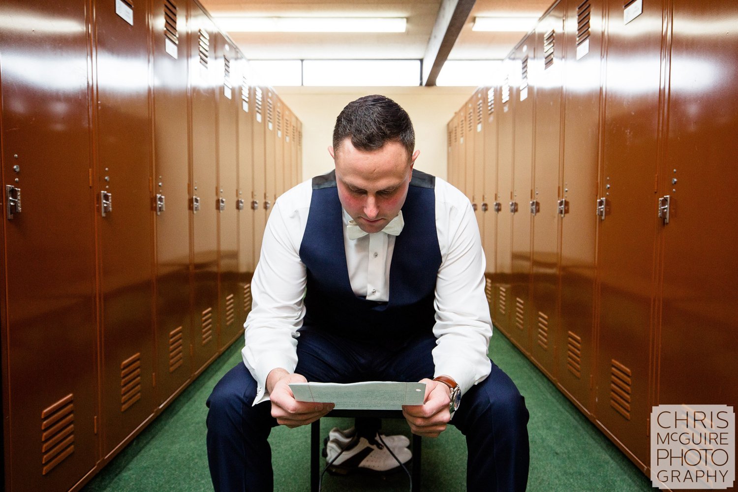 groom reading letter in locker room