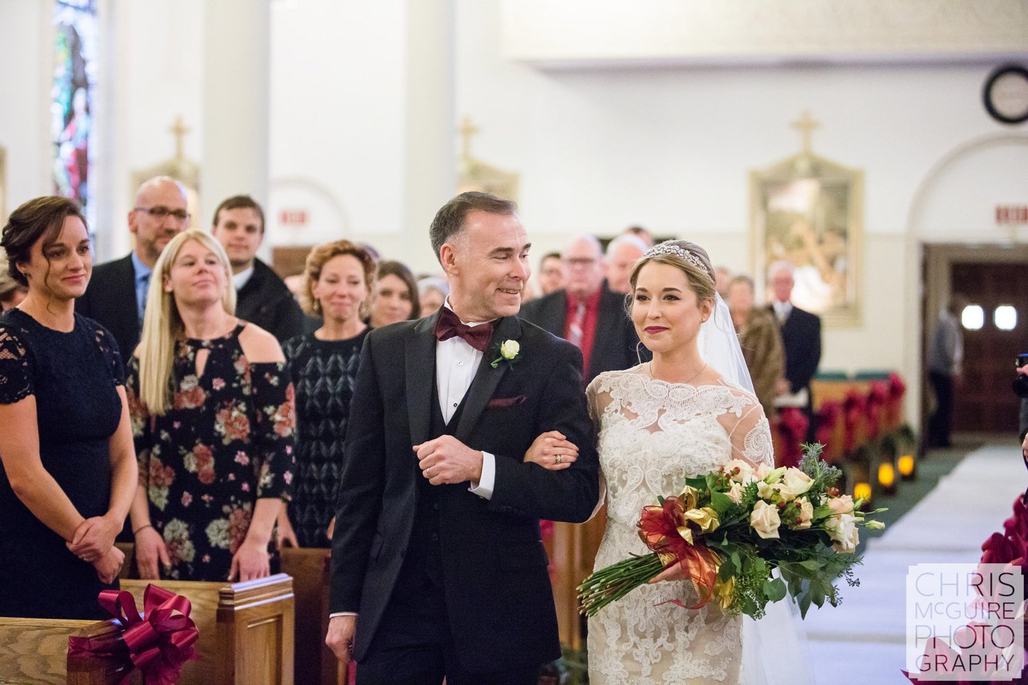 father smiles at bride walking down aisle at wedding