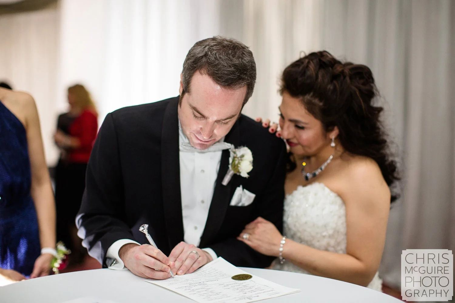 bride groom signing marriage license