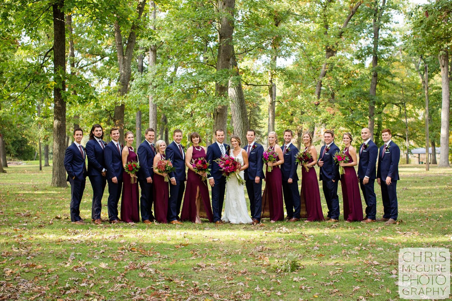 large wedding party at park in fall