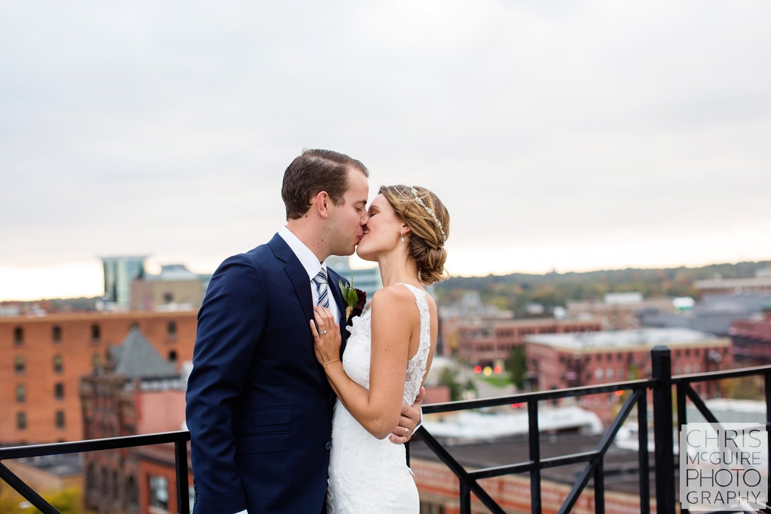 bride groom kiss on rooftop skydeck