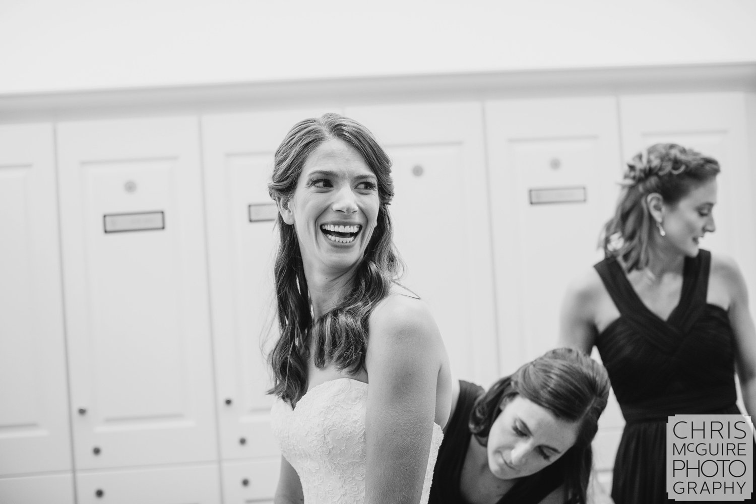 bride laughing while getting ready