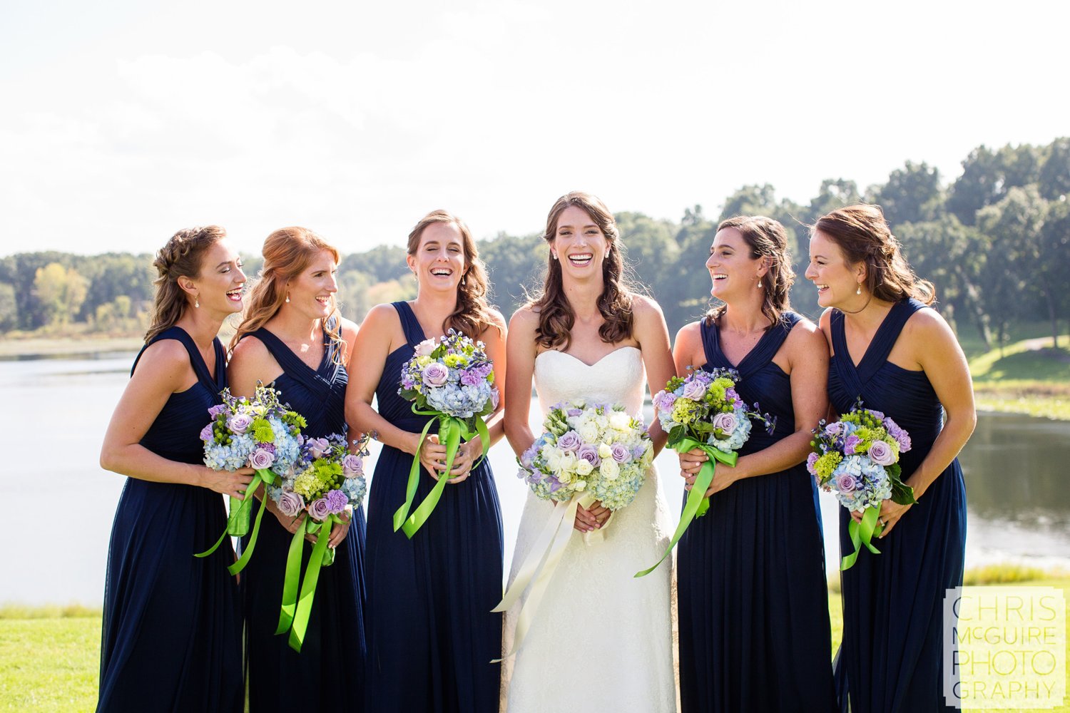 bride bridesmaids laughing with bouquets