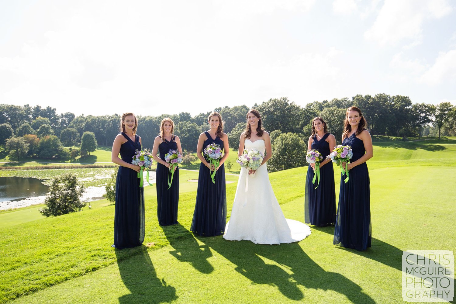 bride bridesmaids with bouquets on golf course