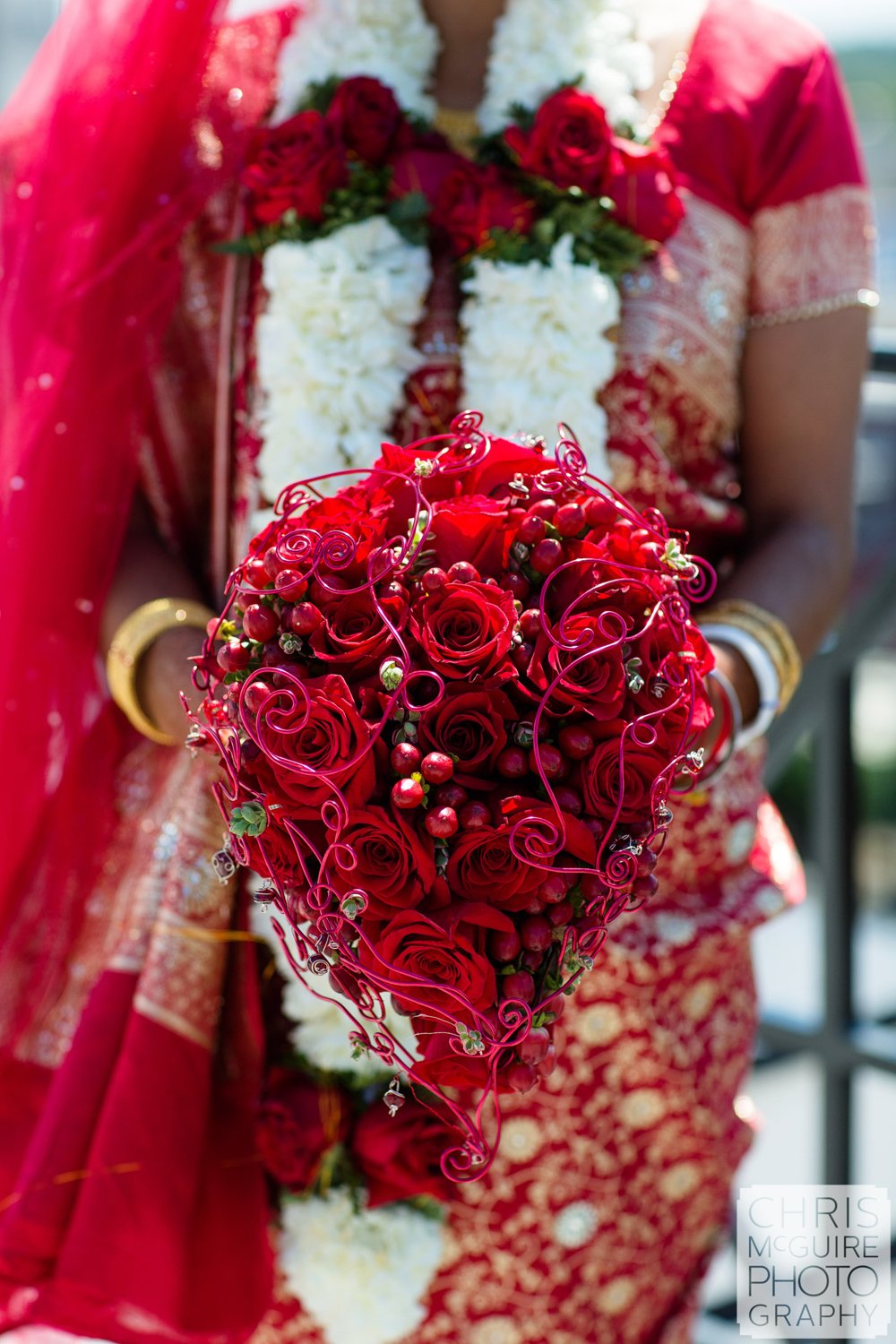 indian bride with rose bouquet