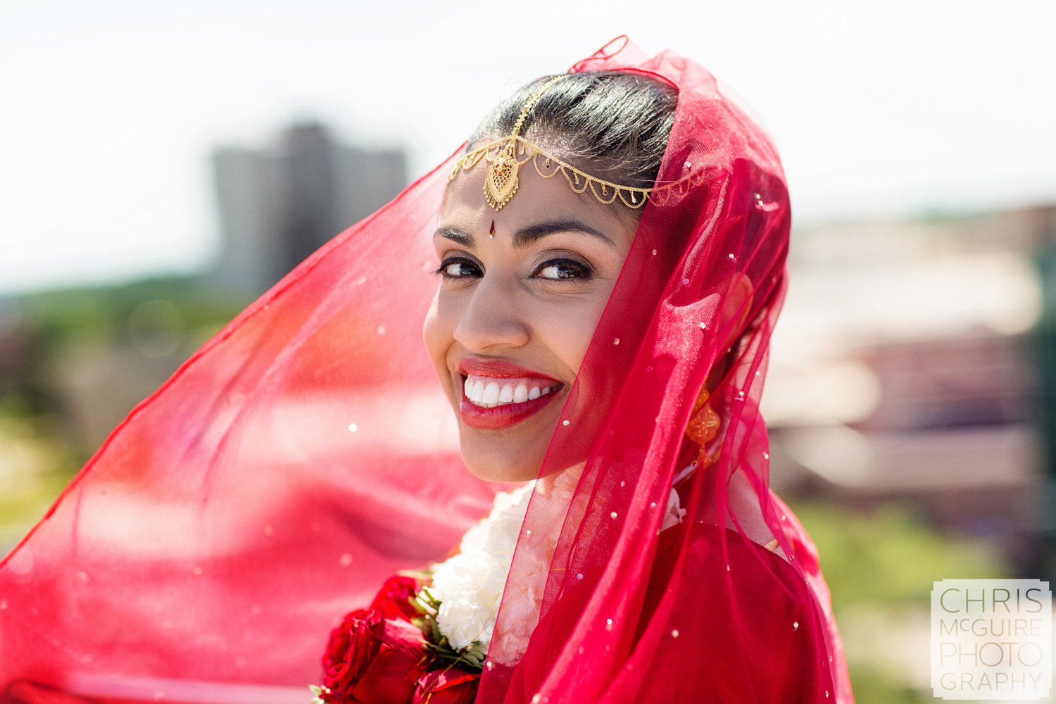 indian bride smiling red veil