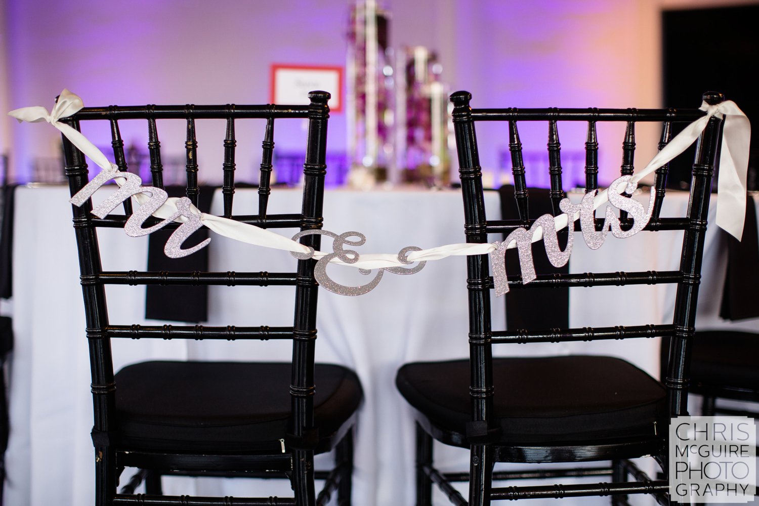 mr and mrs signs on chairs at wedding reception