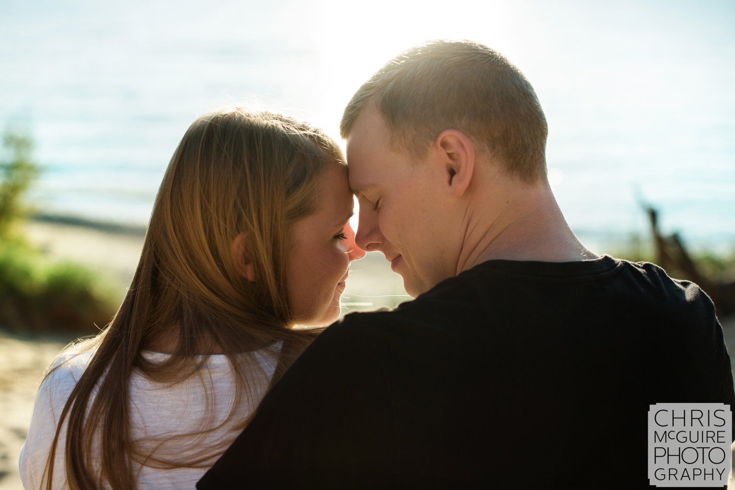 couple foreheads at beach