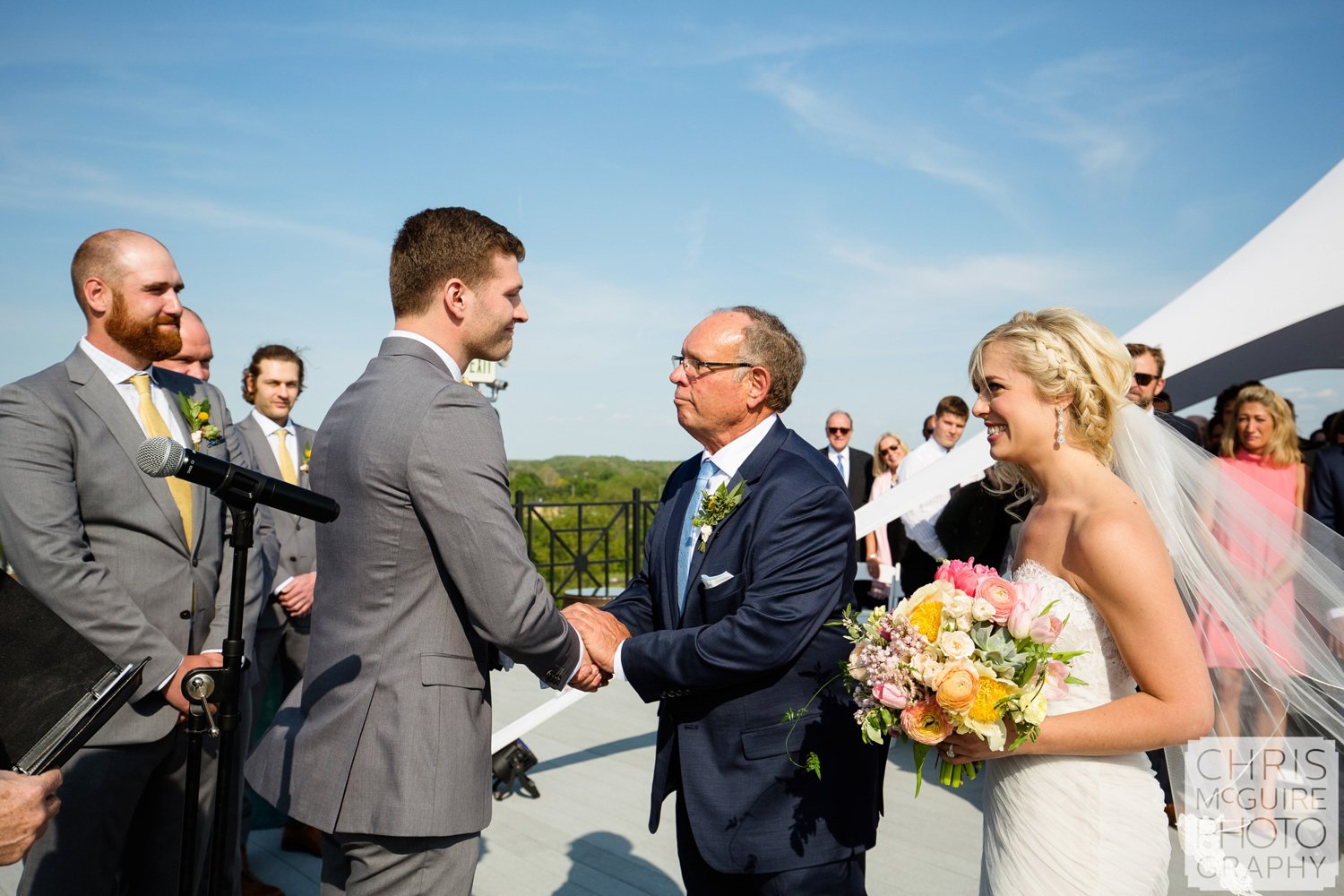 groom and bride's father shake hands at wedding